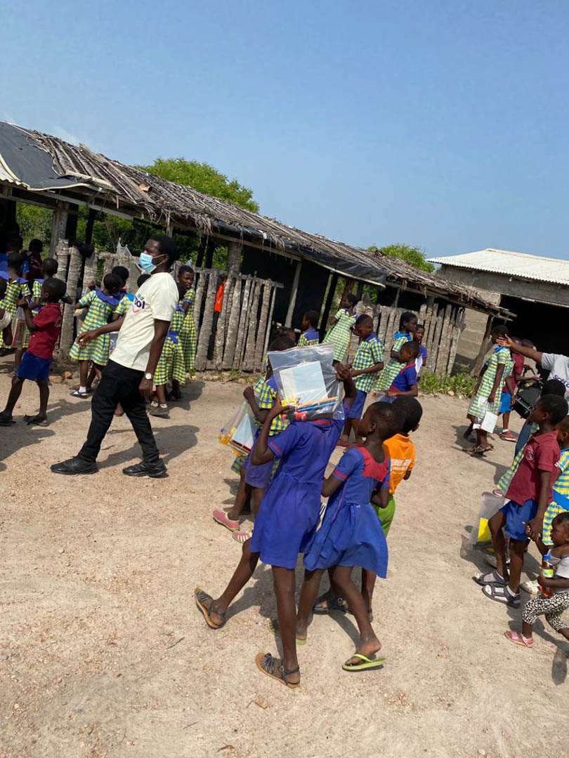 happy needy students entering their mud structured school- courtesy smile at school